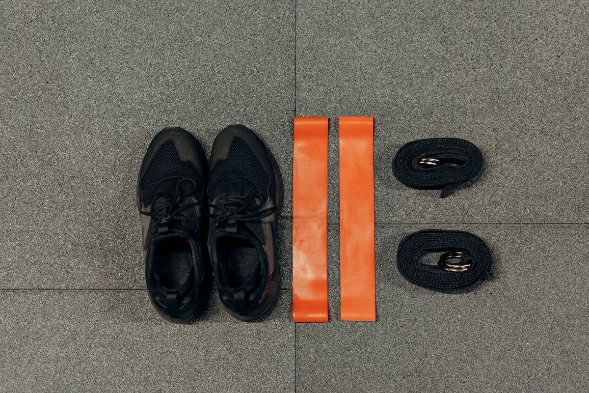 Sports shoes and active accessories flat lay