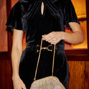 Yumi Black Velvet Jumpsuit with Twist Neckline and Buckle Belt